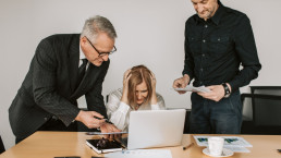 Woman visually stressed due to poor crisis management being supported by colleagues